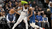Jan 7, 2024; Dallas, Texas, USA; Dallas Mavericks guard Kyrie Irving (11) looks to move the ball past Minnesota Timberwolves guard Mike Conley (10) during the first quarter at the American Airlines Center. Mandatory Credit: Jerome Miron-USA TODAY Sports