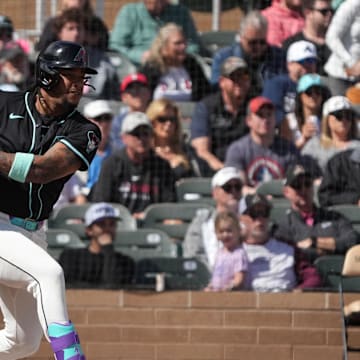 Mar 3, 2025; Salt River Pima-Maricopa, Arizona, USA; Arizona Diamondbacks second base Ketel Marte (4) hits a single against the Chicago Cubs in the first inning at Salt River Fields at Talking Stick. Mandatory Credit: Rick Scuteri-Imagn Images