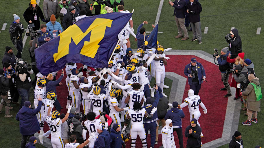Michigan football players plant their team's flag at midfield following their game against the Ohio State Buckeyes at Ohio Stadium.  | Barbara J. Perenic-USA TODAY Network via Imagn Images