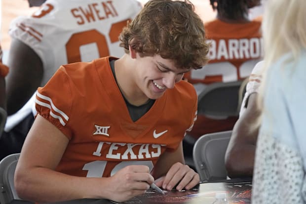 Texas Longhorns quarterback Arch Manning signs autographs for fans before the Texas Spring Game. 