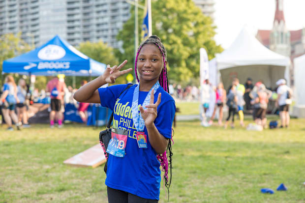 A girl celebrates her victory in a road race.