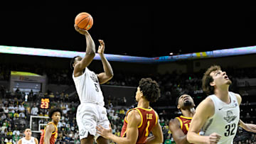 Mar 1, 2025; Eugene, Oregon, USA; Oregon Ducks guard TJ Bamba (5) shoots the ball over USC Trojans guard Desmond Claude (1) during the first half at Matthew Knight Arena. Mandatory Credit: Craig Strobeck-Imagn Images
