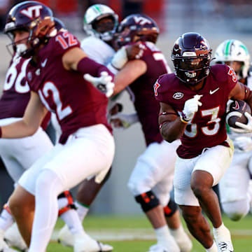 Sep 7, 2024; Blacksburg, Virginia, USA; Virginia Tech Hokies running back Bhayshul Tuten (33) runs the ball during the second quarter against the Marshall Thundering Herd at Lane Stadium. Mandatory Credit: Peter Casey-Imagn Images