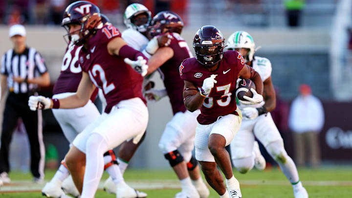 Sep 7, 2024; Blacksburg, Virginia, USA; Virginia Tech Hokies running back Bhayshul Tuten (33) runs the ball during the second quarter against the Marshall Thundering Herd at Lane Stadium. Mandatory Credit: Peter Casey-Imagn Images