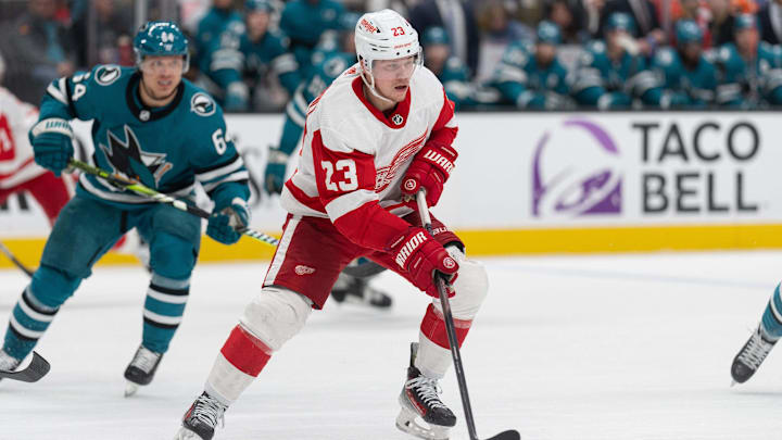 Jan 2, 2024; San Jose, California, USA; Detroit Red Wings left wing Lucas Raymond (23) controls the puck during the first period against the San Jose Sharks at SAP Center at San Jose. Mandatory Credit: Stan Szeto-Imagn Images