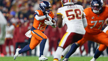 Nov 30, 2025; Landover, Maryland, USA; Denver Broncos running back RJ Harvey (12) carries the ball against the Washington Commanders in the first quarter of the game at Northwest Stadium. Mandatory Credit: Peter Casey-Imagn Images