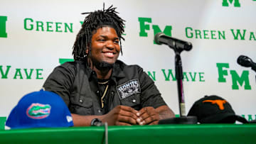 Fort Myers Green Wave defensive lineman Kendall Guervil commits to the University of Florida while surrounded by friends and family during a ceremony at Fort Myers High School in Fort Myers, Fla., on Wednesday, July 2, 2025.