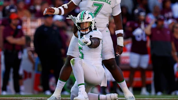 Marshall Thundering Herd defensive lineman Mike Green celebrates after sacking Virginia Tech Hokies quarterback Kyron Drones.