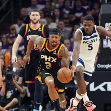 Apr 26, 2024; Phoenix, Arizona, USA; Phoenix Suns guard Bradley Beal (3) dribbles by Minnesota Timberwolves guard Anthony Edwards (5) during the second half of game three of the first round for the 2024 NBA playoffs at Footprint Center. Mandatory Credit: Joe Camporeale-USA TODAY Sports