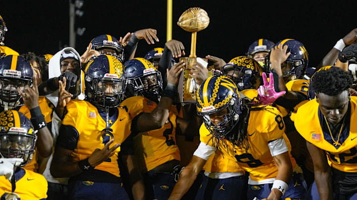 The Naples football team celebrates a win over Lely in the 51st annual Coconut Bowl at Staver Field in Naples on Friday, Oct. 18, 2024. Naples won 36-12.