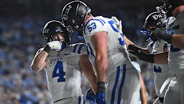 Nov 22, 2025; Chapel Hill, North Carolina, USA; Duke Blue Devils running back Anderson Castle (4) celebrates a touchdown with offensive lineman Brian Parker II (53) during the second half against North Carolina at Kenan Stadium. Mandatory Credit: William Howard-Imagn Images