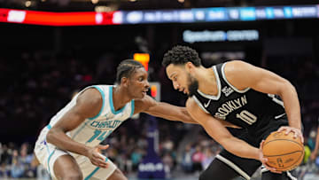 Jan 29, 2025; Charlotte, North Carolina, USA; Brooklyn Nets guard Ben Simmons (10) handles the ball defended by Charlotte Hornets forward Moussa Diabate (14) during the first quarter at Spectrum Center. Mandatory Credit: Jim Dedmon-Imagn Images