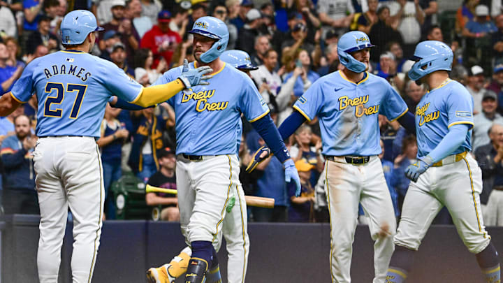 Sep 27, 2024; Milwaukee, Wisconsin, USA; Milwaukee Brewers first baseman Rhys Hoskins (12) celebrates with shortstop Willy Adames (27) after hitting a grand slam home run against the New York Mets in the first inning at American Family Field. Mandatory Credit: Benny Sieu-Imagn Images