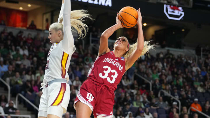 Mar 29, 2024; Albany, NY, USA; Indiana Hoosiers guard Sydney Parrish (33) shoots a layup against South Carolina Gamecocks forward Chloe Kitts (21) during the first half in the semifinals of the Albany Regional of the 2024 NCAA Tournament at the MVP Arena at MVP Arena. Mandatory Credit: Gregory Fisher-USA TODAY Sports