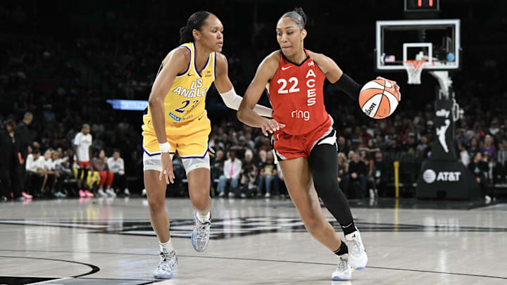 Las Vegas Aces center Wilson drives past Los Angeles Sparks forward Stevens at Michelob Ultra Arena. 