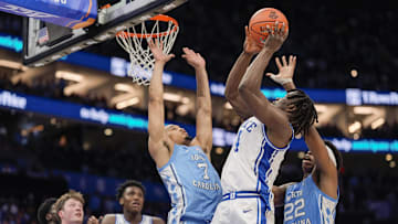 Mar 14, 2025; Charlotte, NC, USA; Duke Blue Devils guard Sion James (14) goes to the basket against North Carolina Tar Heels guard Seth Trimble (7) and forward Ven-Allen Lubin (22)  during the second half at Spectrum Center. Mandatory Credit: Jim Dedmon-Imagn Images
