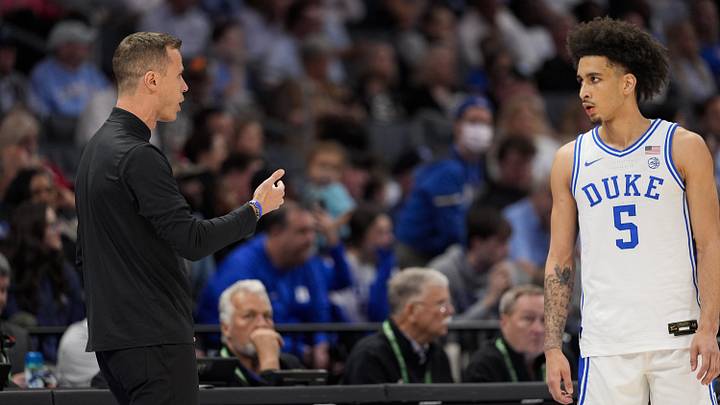 Mar 14, 2025; Charlotte, NC, USA; Duke basketball head coach Jon Scheyer talks with guard Tyrese Proctor (5) during a free throw  during the first half against the North Carolina Tar Heels at Spectrum Center.