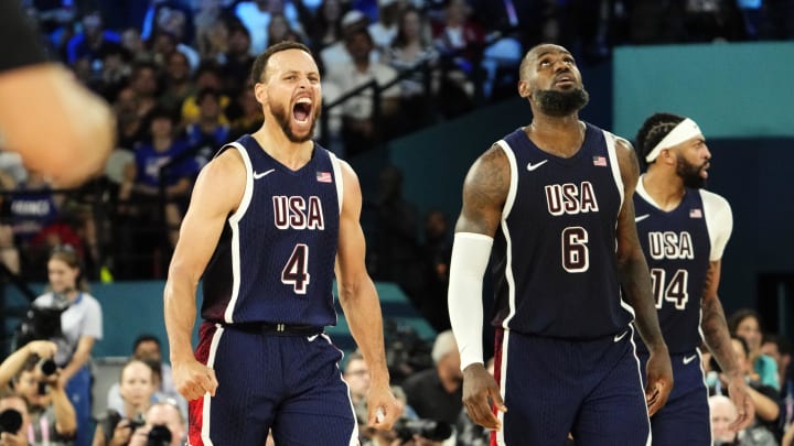 Aug 10, 2024; Paris, France; United States guard Stephen Curry (4) and forward LeBron James (6) react in the second half against France in the men's basketball gold medal game during the Paris 2024 Olympic Summer Games at Accor Arena. 