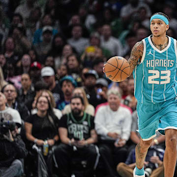 Nov 1, 2024; Charlotte, North Carolina, USA; Charlotte Hornets guard Tre Mann (23) brings the ball up court against the Boston Celtics during the second half at the Spectrum Center. Mandatory Credit: Jim Dedmon-Imagn Images