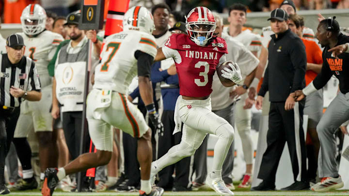 Indiana Hoosiers wide receiver Omar Cooper Jr. (3) runs down the sideline past Miami (FL) Hurricanes defenders Monday, Jan. 19, 2026, during the College Football Playoff National Championship college football game at Hard Rock Stadium in Miami Gardens.