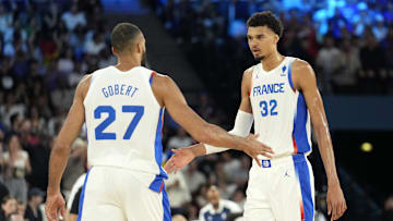 Aug 8, 2024; Paris, France; France centre Rudy Gobert (27) and power forward Victor Wembanyama (32) celebrate during the first half against Germany in a men's basketball semifinal game during the Paris 2024 Olympic Summer Games at Accor Arena. Mandatory Credit: Kyle Terada-Imagn Images