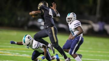 Plant's Waltez Clark hurdling a Sumner defender in a 2022 region quarterfinal contest 