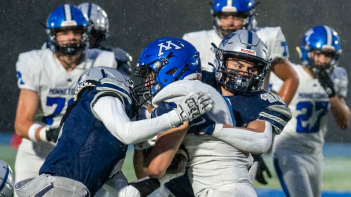 A Champlin Park defender tackles a Minnetonka running back in 2022.