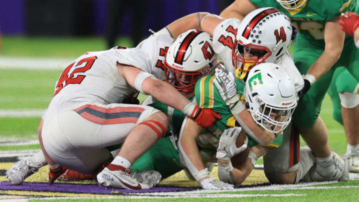 Centennial defenders rally for a tackle against Edina in the 2023 Prep Bowl