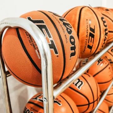 A Simi Valley man who worked as an assistant basketball coach at a local high school has been charged with committing lewd acts involving two teenage girls.