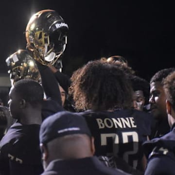 Narbonne football players in a huddle before a game.