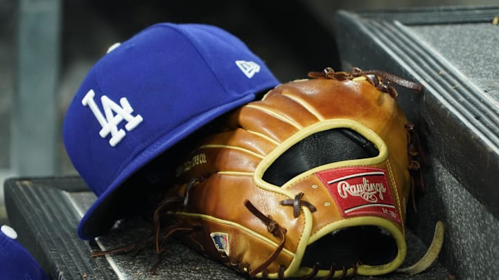 Apr 28, 2024; Toronto, Ontario, CAN; A hat and glove of an Los Angeles Dodgers player durng a game against the Toronto Blue Jays at Rogers Centre. Mandatory Credit: John E. Sokolowski-Imagn Images