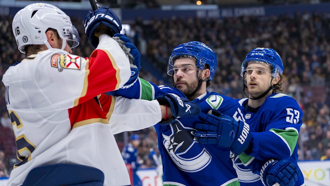 Dec 12, 2024; Vancouver, British Columbia, CAN;  Vancouver Canucks defenseman Mark Friedman (51) and forward Teddy Blueger (53) battle with Florida Panthers forward Aleksander Barkov (16) during the first period at Rogers Arena. Mandatory Credit: Bob Frid-Imagn Images