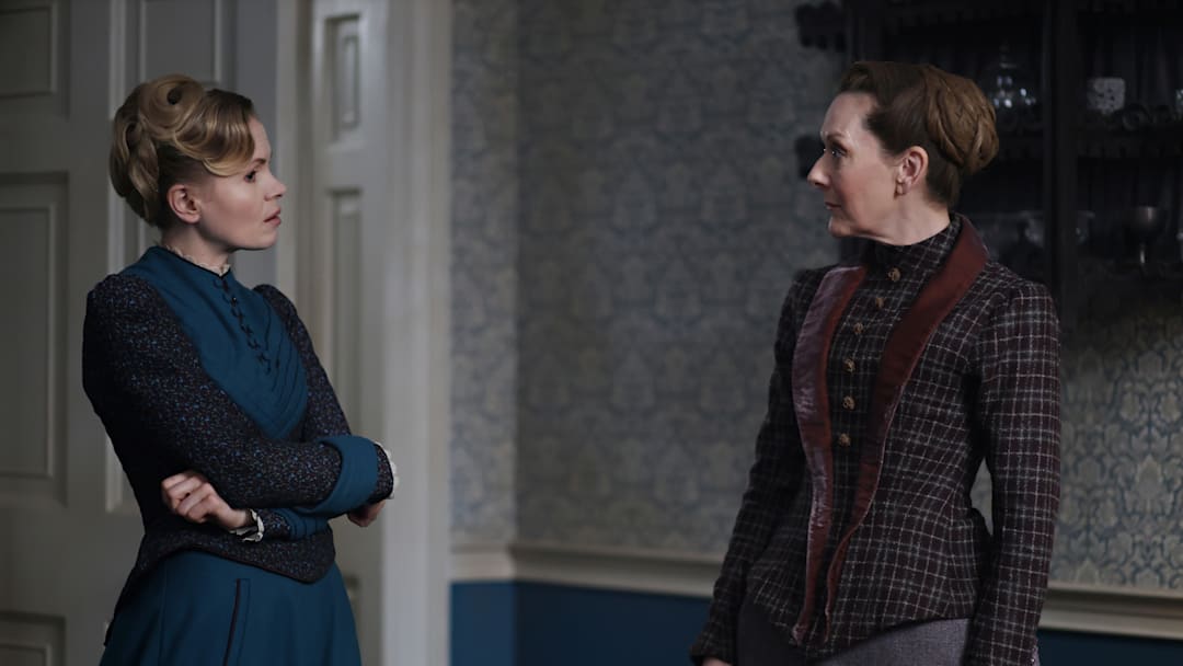 MASTERPIECE
Miss Scarlet, Season 6 
 
Streaming Dec. 7, 2025 on the PBS app
Premiering Jan. 11, 2026 on PBS

Episode One: Secrets and Lies
In a case centered around the fledgling world of psychiatry, a violent psychiatric patient is on the loose, leaving behind a murder, a mystery and an unidentified body. Blake hires Eliza to help him solve the case.

Shown L-R: Eliza Scarlet (Kate Phillips), Ivy Potts (Cathy Belton)

Photographer: Maja Medic
 
For editorial use only.
 
Courtesy of Miss Scarlet