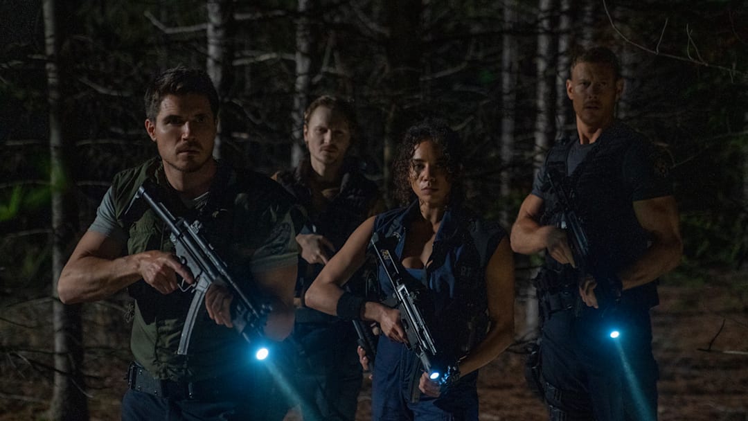 Robbie Amell, Chad Rook, Hannah John Kamen, and Tom Hopper in Screen Gems RESIDENT EVIL WELCOME TO RACCOON CITY.
