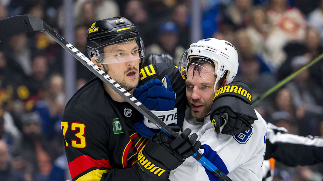 Dec 8, 2024; Vancouver, British Columbia, CAN; Vancouver Canucks defenseman Vincent Desharnais (73) wrestles with Tampa Bay Lightning forward Zemgus Girgensons (28) during the third period at Rogers Arena. Mandatory Credit: Bob Frid-Imagn Images