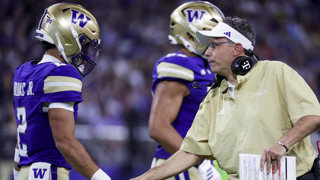 Sep 6, 2025; Seattle, Washington, USA; Washington Huskies head coach Jedd Fisch talks with quarterback Demond Williams Jr. (2) during a first quarter timeout against the UC Davis Aggies at Husky Stadium. Mandatory Credit: Joe Nicholson-Imagn Images