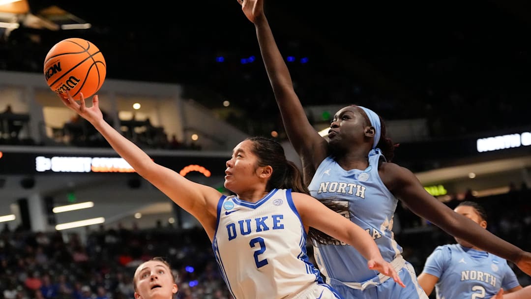 Mar 28, 2025; Birmingham, AL, USA; Duke Blue Devils guard Vanessa de Jesus (2) slips past North Carolina Tar Heels center Maria Gakdeng (5) for two points at Legacy Arena in the Sweet 16.