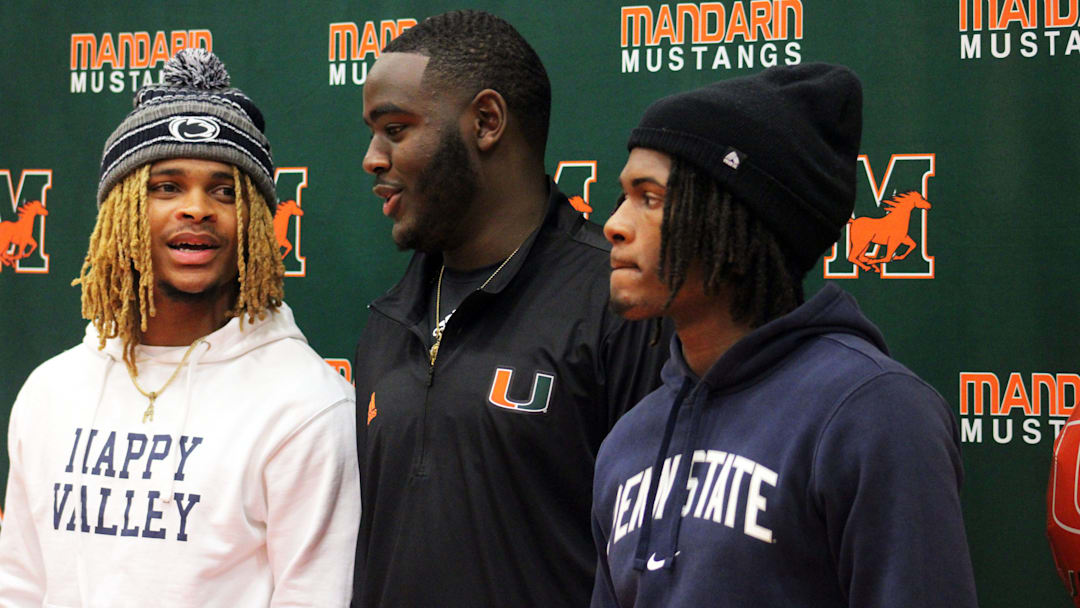 Mandarin cornerback A.J. Belgrave-Shorter (Penn State), offensive tackle Deryc Plazz (Miami) and cornerback Jon Mitchell (Penn State) talk after signing national letters of intent for college football on December 20, 2023. [Clayton Freeman/Florida Times-Union]