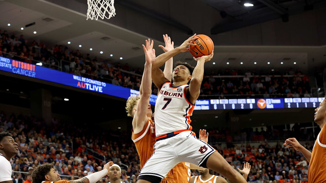 Jan 28, 2026; Auburn, Alabama, USA;  Auburn Tigers guard Keyshawn Hall (7) goes up for a shot against Texas Longhorns center Matas Vokietaitis (8) during the second half at Neville Arena.  Hall scored 31 points as Auburn beat Texas 88-82. Mandatory Credit: John Reed-Imagn Images