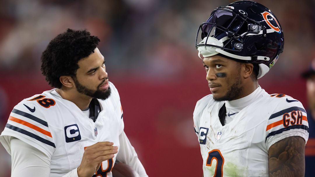 Nov 3, 2024; Glendale, Arizona, USA; Chicago Bears quarterback Caleb Williams (18) talks with wide receiver DJ Moore (2) against the Arizona Cardinals at State Farm Stadium. Mandatory Credit: Mark J. Rebilas-Imagn Images