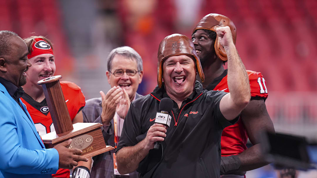 Aug 31, 2024; Atlanta, Georgia, USA; Georgia Bulldogs head coach Kirby Smart wears the old leather helmet after defeating the Clemson Tigers at Mercedes-Benz Stadium. Mandatory Credit: Dale Zanine-Imagn Images