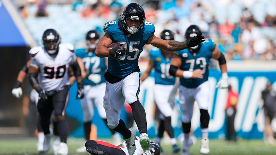 Jacksonville Jaguars tight end Brenton Strange (85) rushes for yards leaping past Houston Texans safety Jalen Pitre (5) during the third quarter of an NFL football matchup at EverBank Stadium, Sunday, Sept. 21, 2025, in Jacksonville, Fla. The Jaguars defeated the Texans 17-10.
