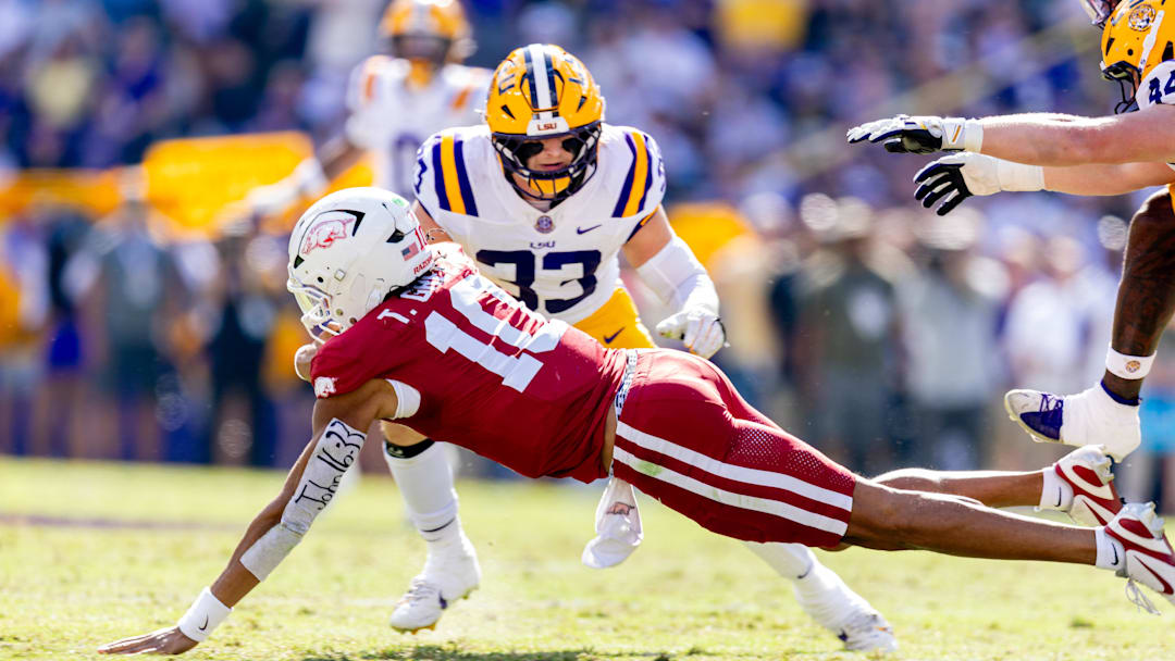 Arkansas Razorbacks quarterback Taylen Green (10) is tackled by LSU Tigers defensive end Jack Pyburn (44) during the first half at Tiger Stadium. 