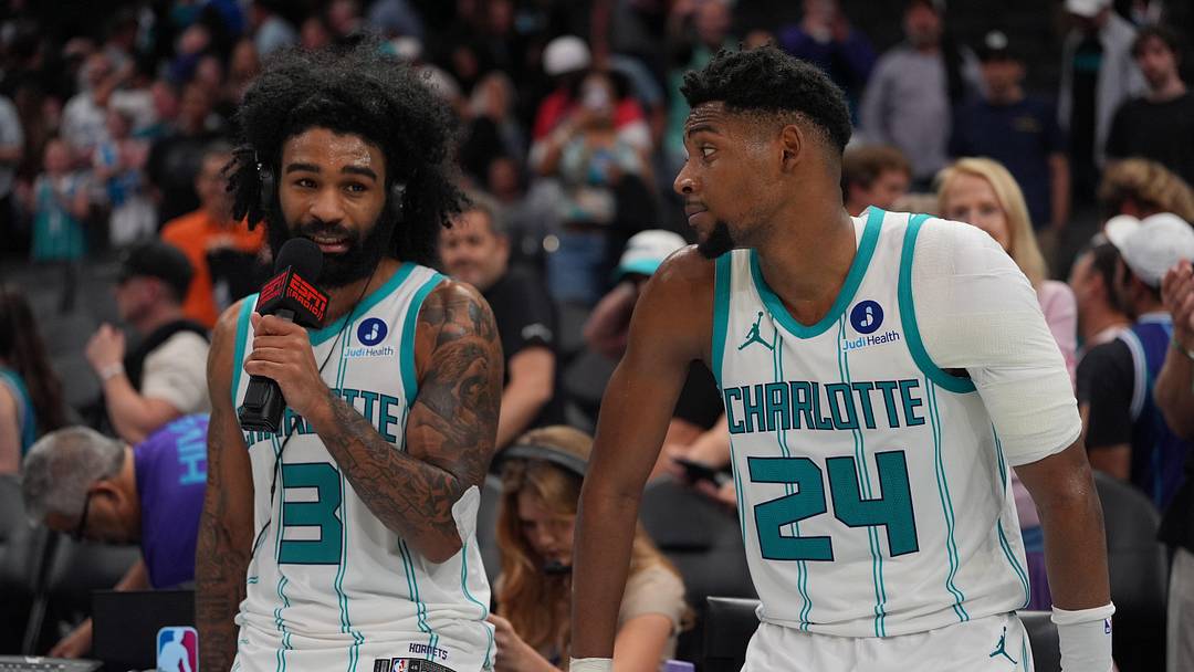 Charlotte Hornets guard Coby White (3) alongside forward Brandon Miller (24) give an interview after the overtime win 