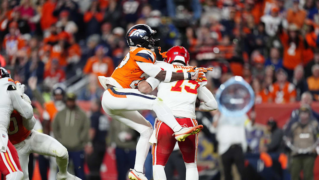 Nov 16, 2025; Denver, Colorado, USA; Denver Broncos cornerback Ja'Quan McMillian (29) sacks Kansas City Chiefs quarterback Patrick Mahomes (15) in the fourth quarter at Empower Field at Mile High. Mandatory Credit: Ron Chenoy-Imagn Images