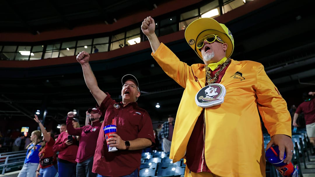 Eric Whisler, right, and brother Erroll Whisler, both from Gainesville, Fla. sing the Florida State fight song after the conclusion of the baseball game Tuesday, March 25, 2025 at VyStar Ballpark in Jacksonville, Fla. FSU rallied to defeat UF 8-4 off a walk-off grand slam from Alex Lodise in the ninth inning. [Corey Perrine/Florida Times-Union]