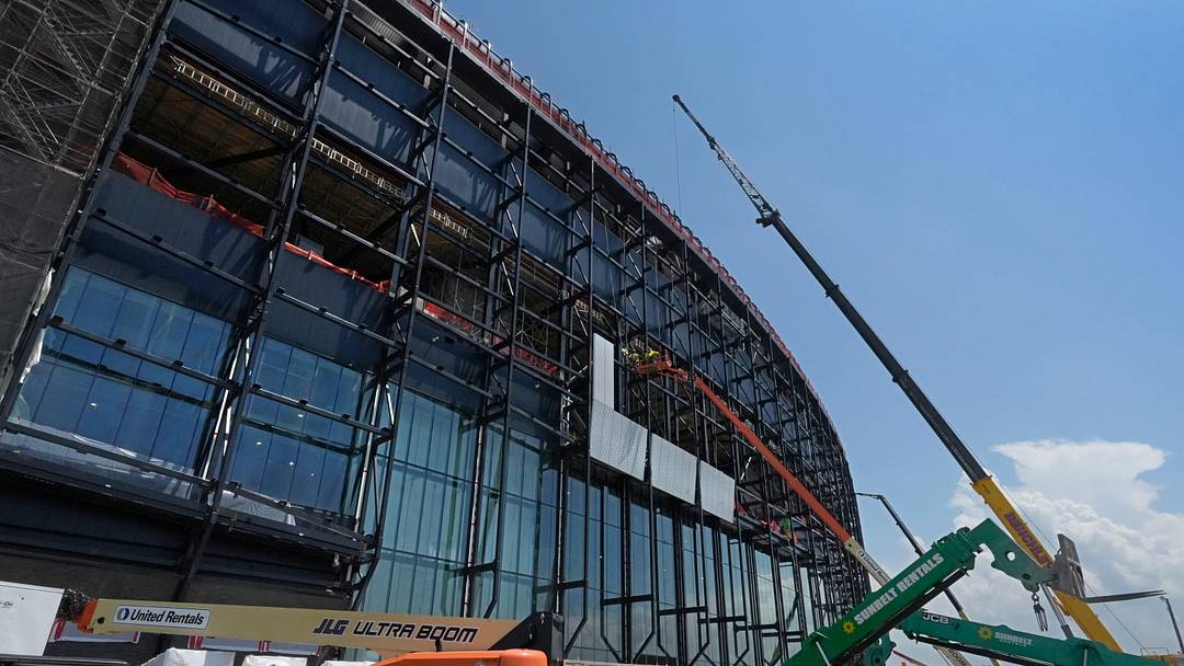 Construction crews install the first panels on the stadium exterior as work continues on the Buffalo Bills new stadium, across the street from their current home at Highmark Stadium, in Orchard Park, NY Thursday, July 10, 2025.
