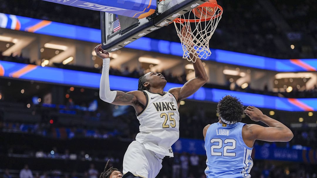 Mar 13, 2025; Charlotte, NC, USA; Wake Forest Demon Deacons forward Tre'Von Spillers (25) tries for a layup defended by North Carolina Tar Heels forward Ven-Allen Lubin (22) during the second half at Spectrum Center. Mandatory Credit: Jim Dedmon-Imagn Images