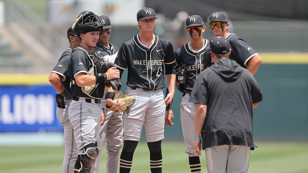 May 25, 2024; Charlotte, NC, USA; Wake Forest head coach Tom Walter approaches the mound to talk with Wake Forest pitcher Josh Hartle (23) in the second inning against Florida State during the ACC Baseball Tournament at Truist Field. Mandatory Credit: Cory Knowlton-Imagn Images