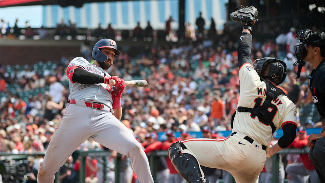 Apr 10, 2024; San Francisco, California, USA; Washington Nationals first baseman Joey Gallo (24) leans back to avoid an inside pitch against San Francisco Giants catcher Tom Murphy (19) during the ninth inning at Oracle Park. 